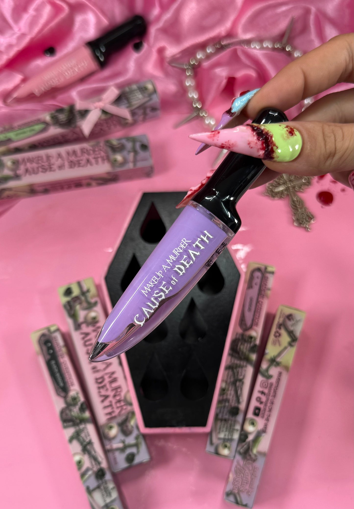 Makeup product with 'Cause of Death' text on a pink background
