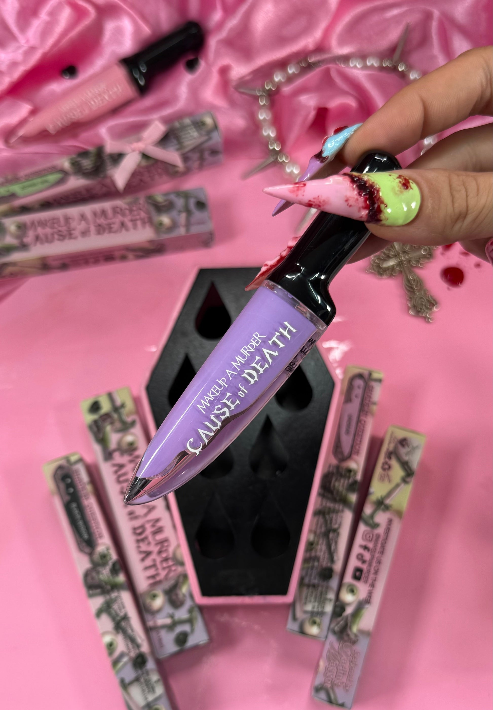 Makeup product with 'Cause of Death' text on a pink background
