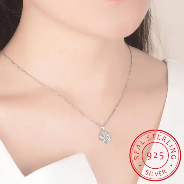 Silver necklace with a pendant on a person's neck, featuring a 'Real Sterling Silver 925' stamp.
