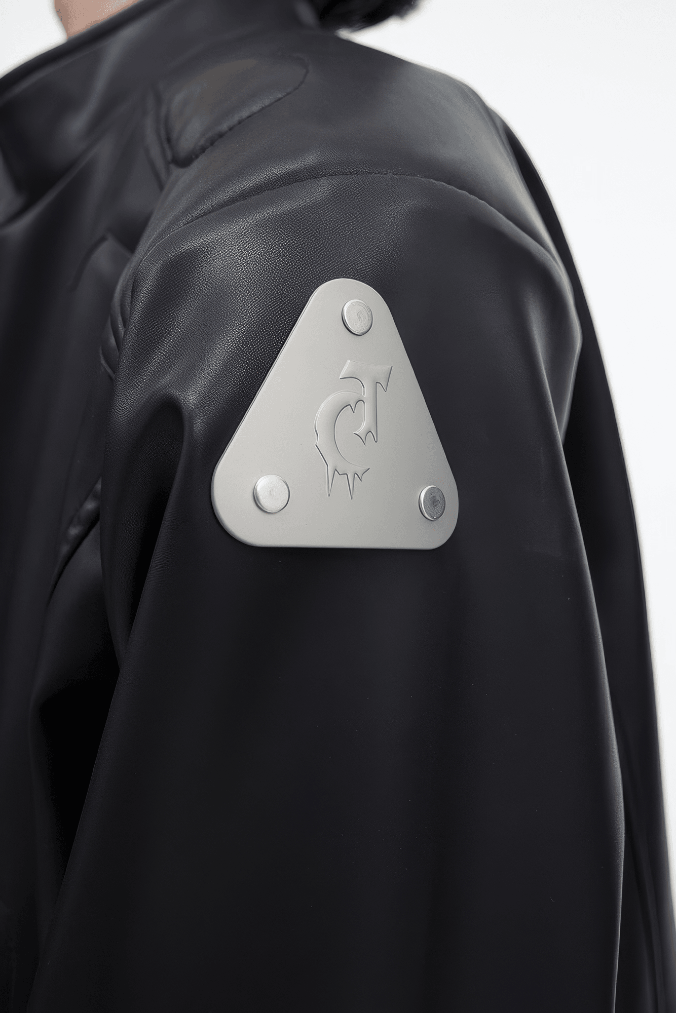 Short Leather Jacket – Modern Sculptural Design with Metal Logo