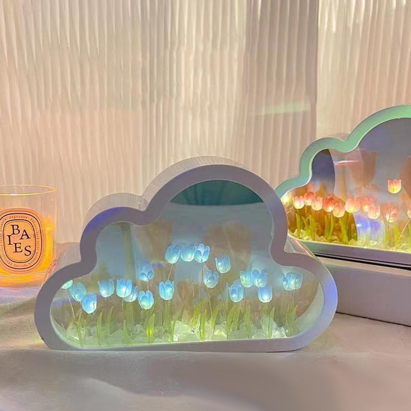 Decorative cloud-shaped lamp with glowing blue and green lights on a surface.